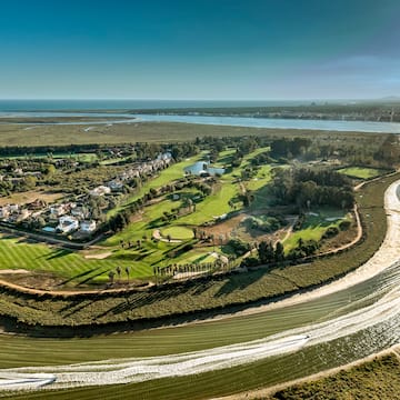 a landscape with a river and a green field