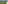 Drone view of coastal golf course with river, speedboats, and residential area.