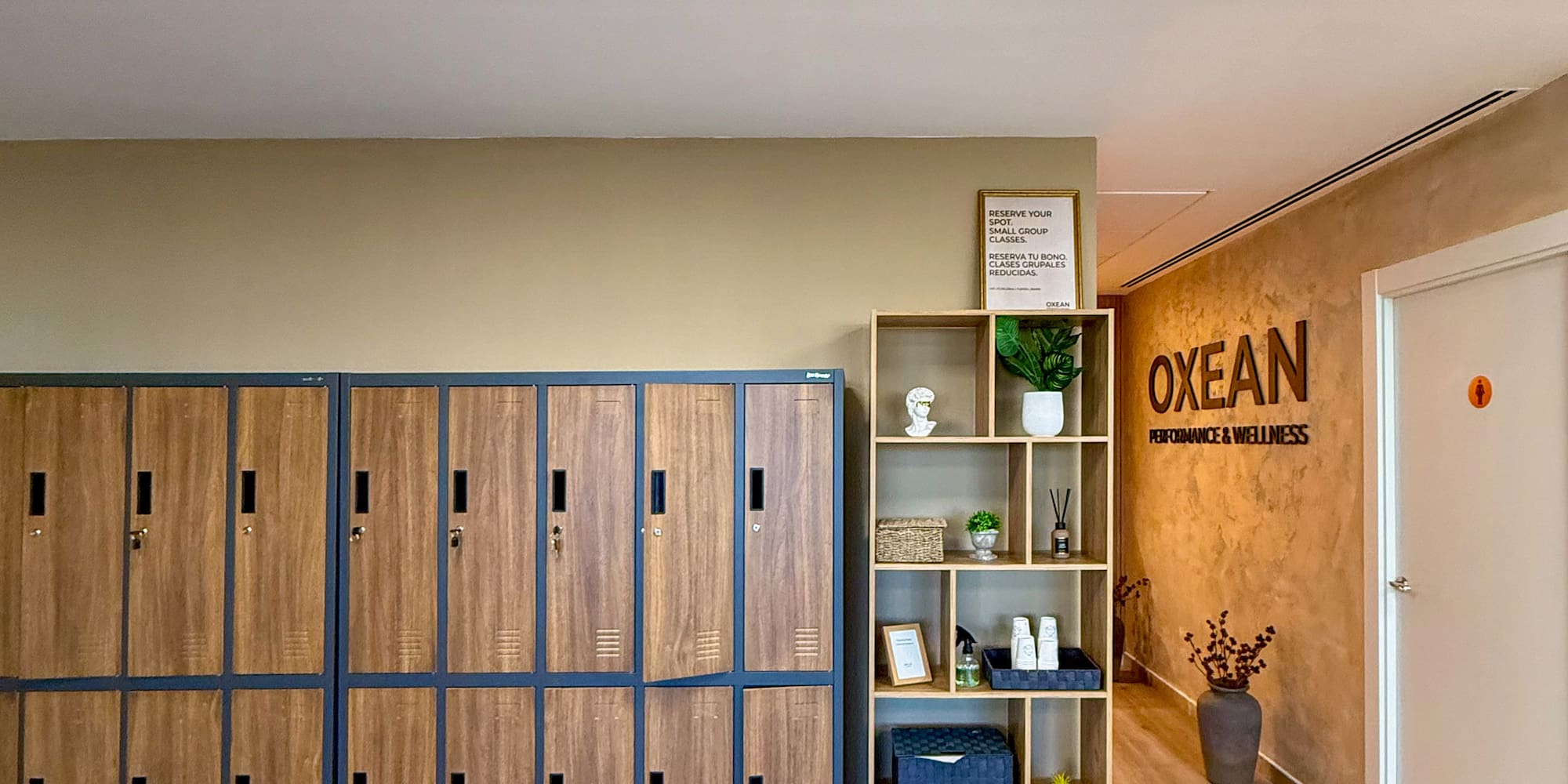 Modern OXEAN changing room with wooden lockers and decor.