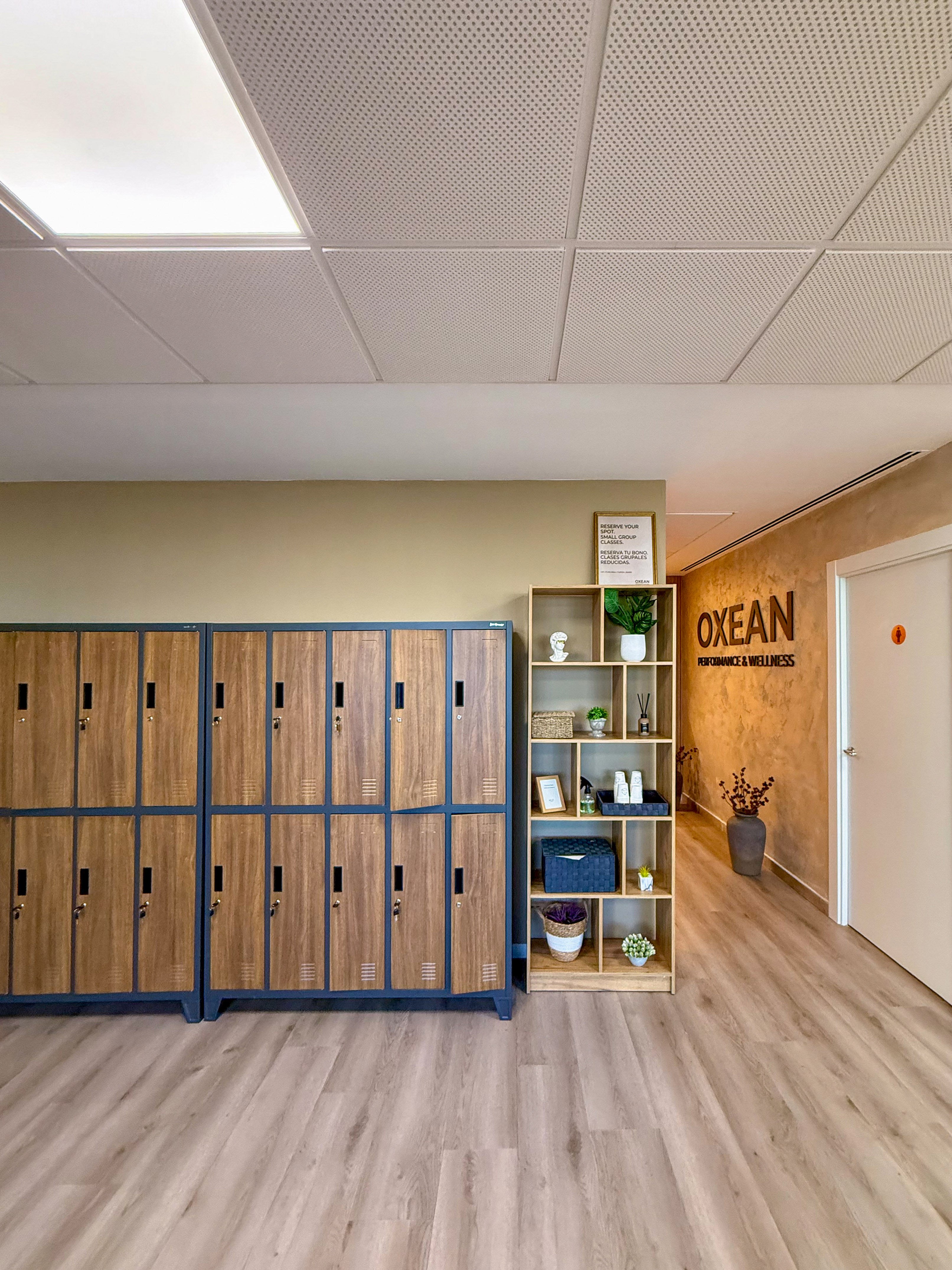 Modern OXEAN changing room with wooden lockers and decor.