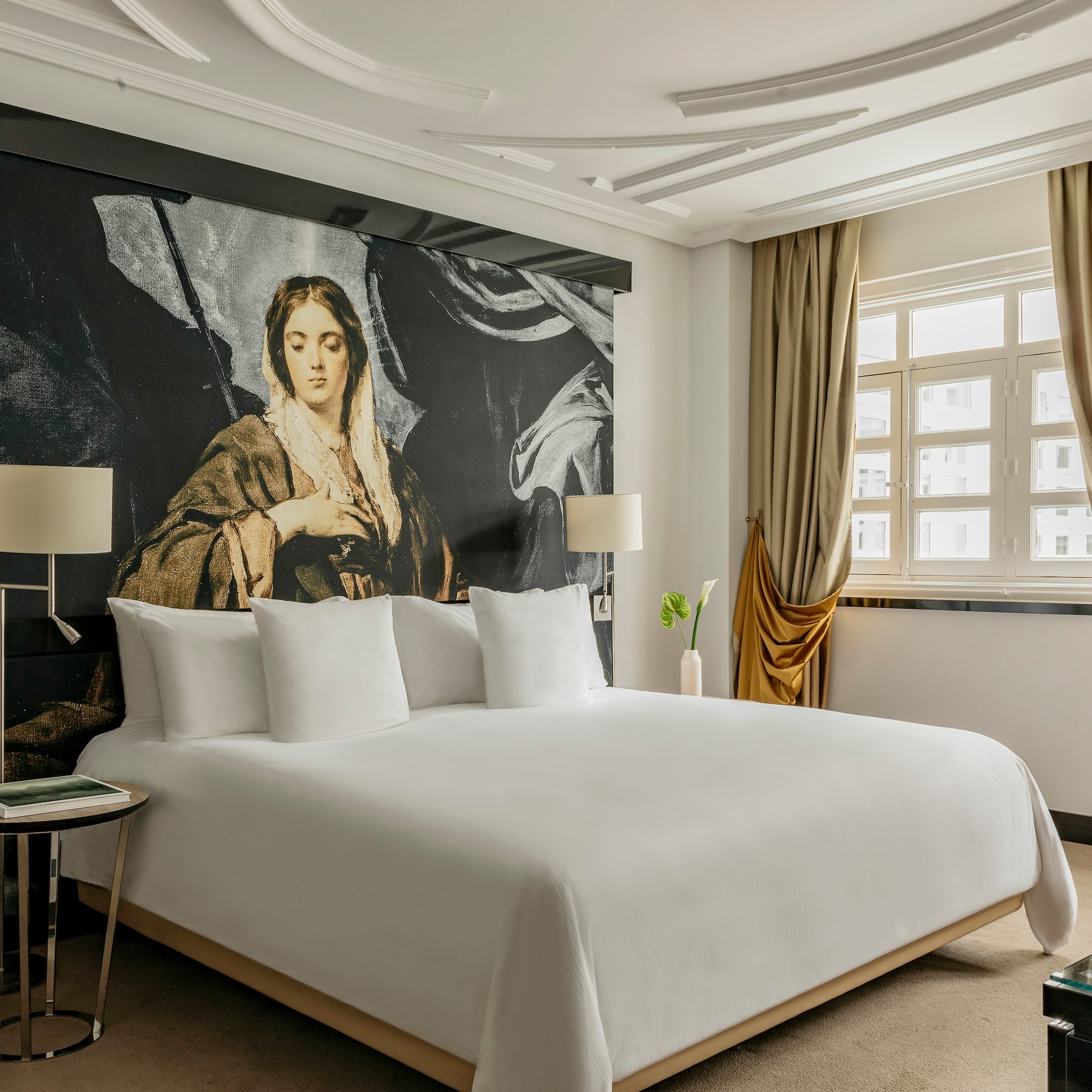 a bed with a large painting on the wall