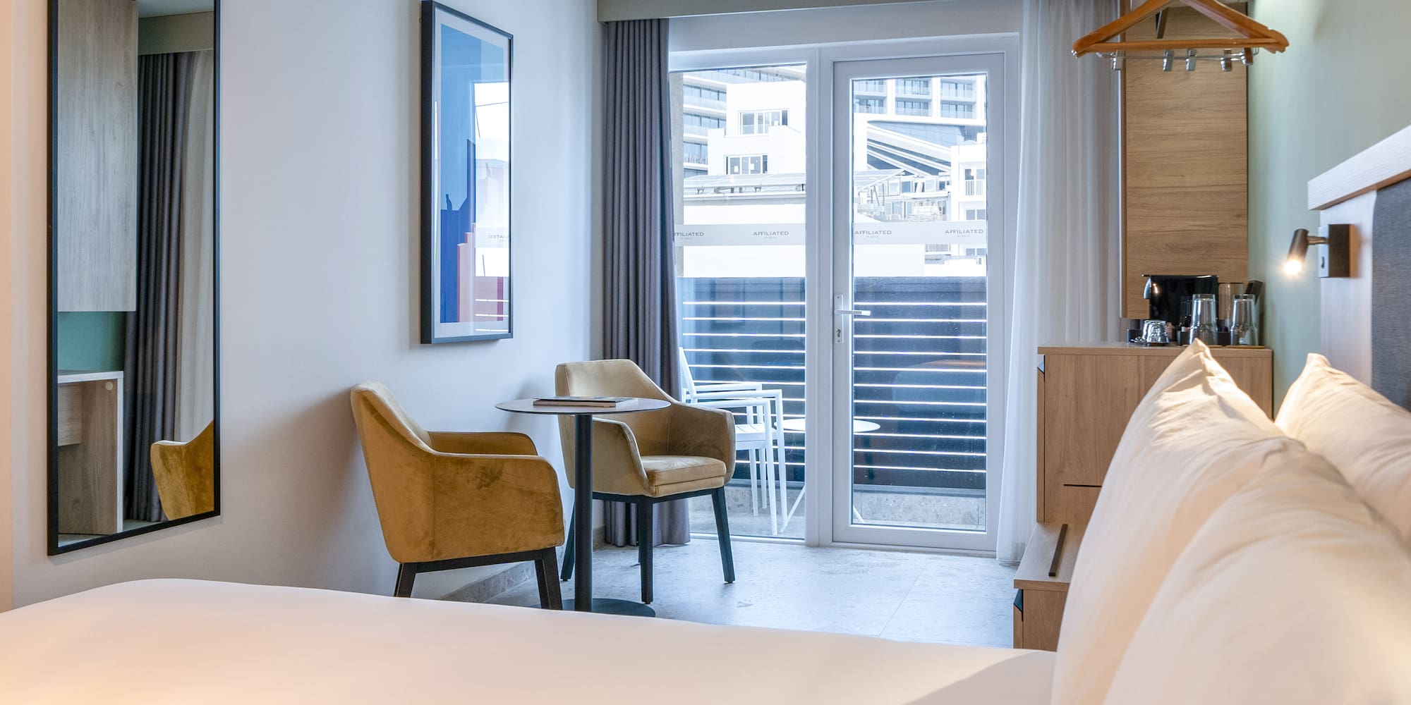 a room with a bed and chairs