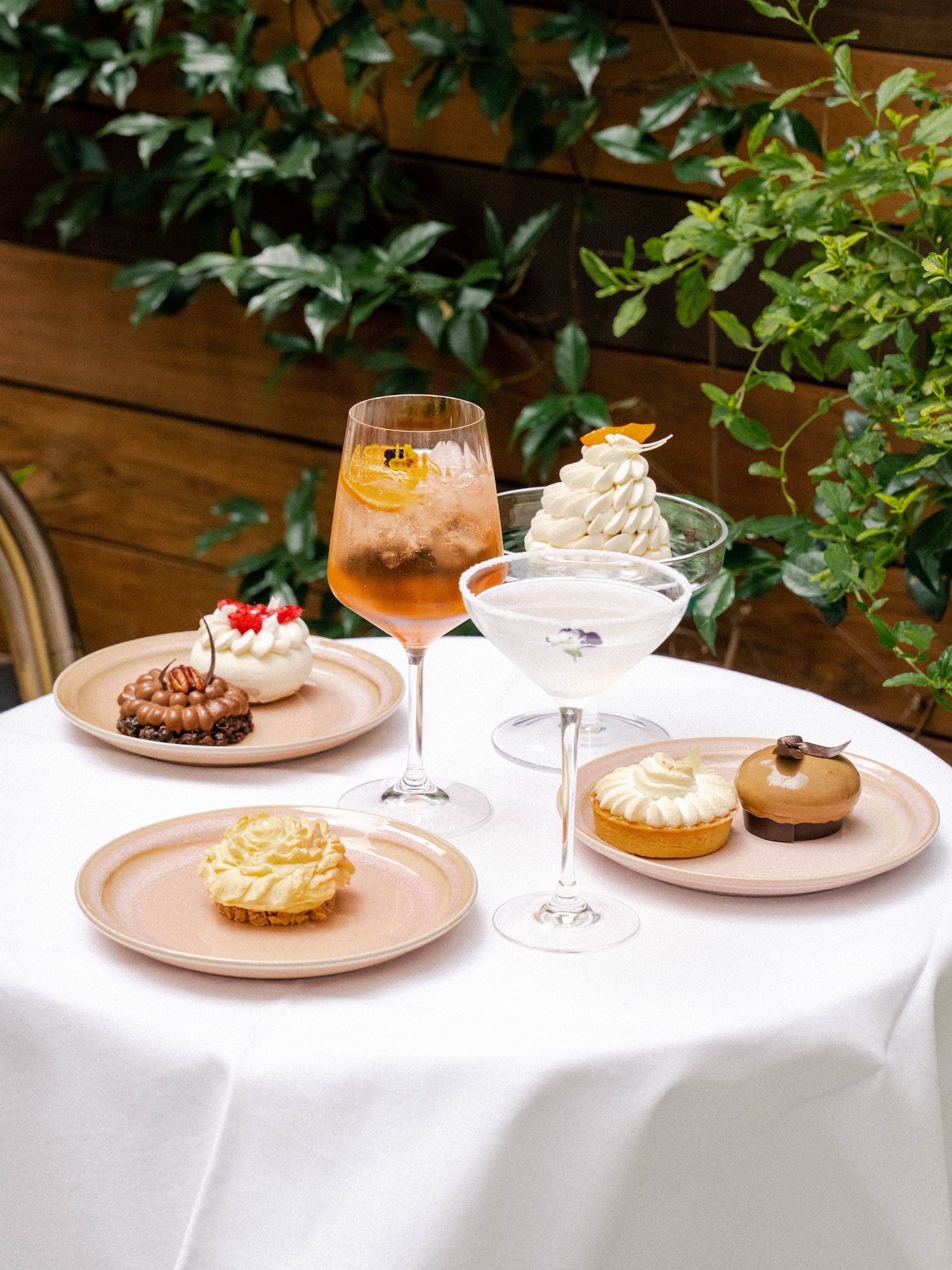 a table with plates of desserts and drinks