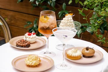 a table with plates of desserts and drinks