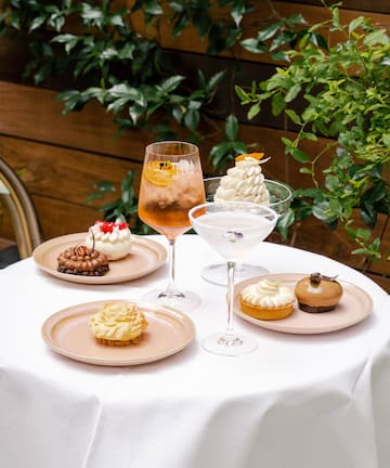 a table with plates of desserts and drinks