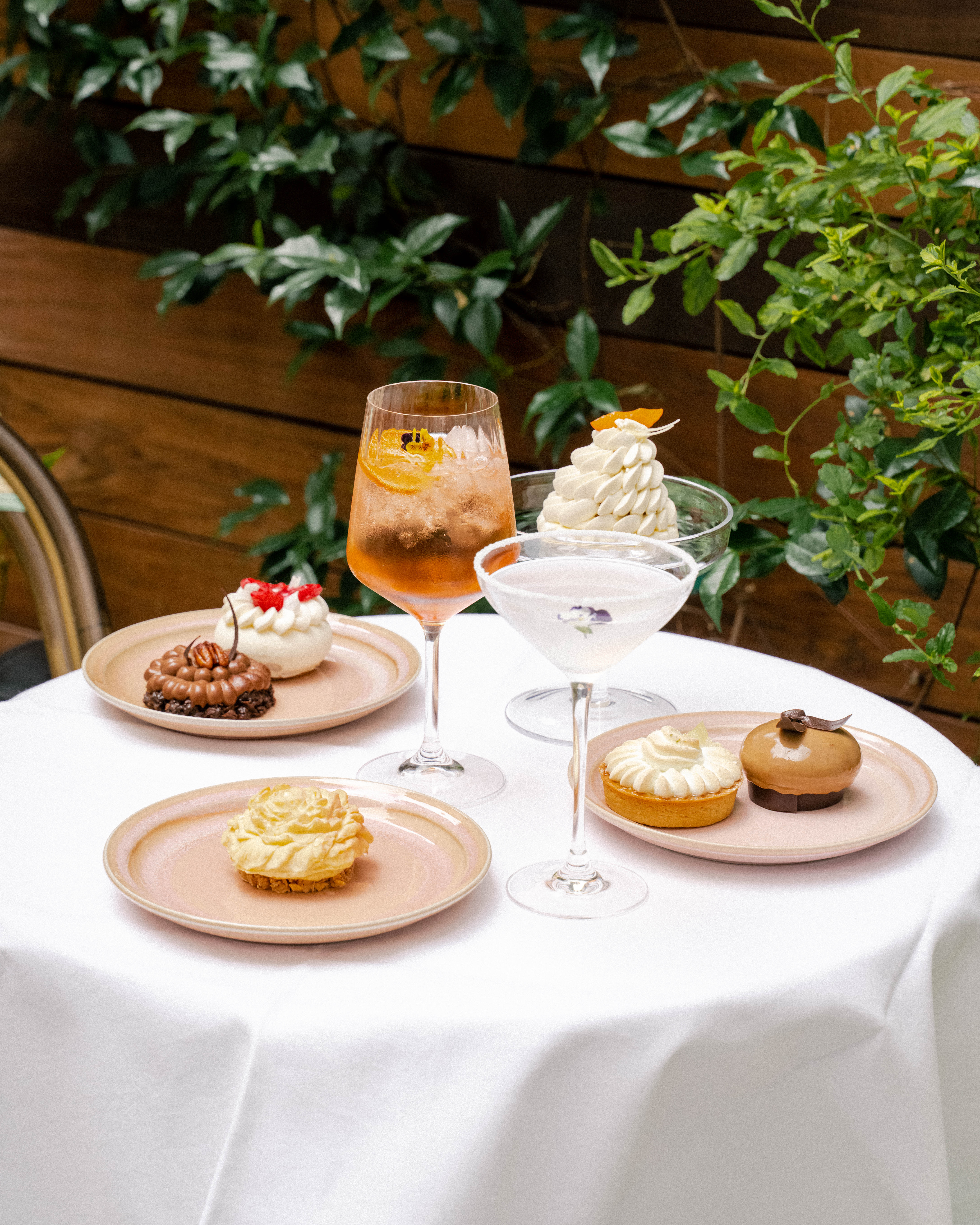 a table with plates of desserts and drinks