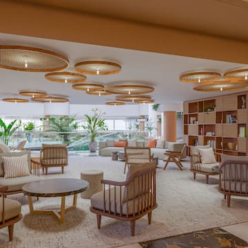 a room with a large round table and chairs