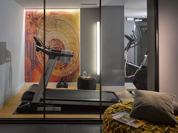 a room with a treadmill and exercise equipment