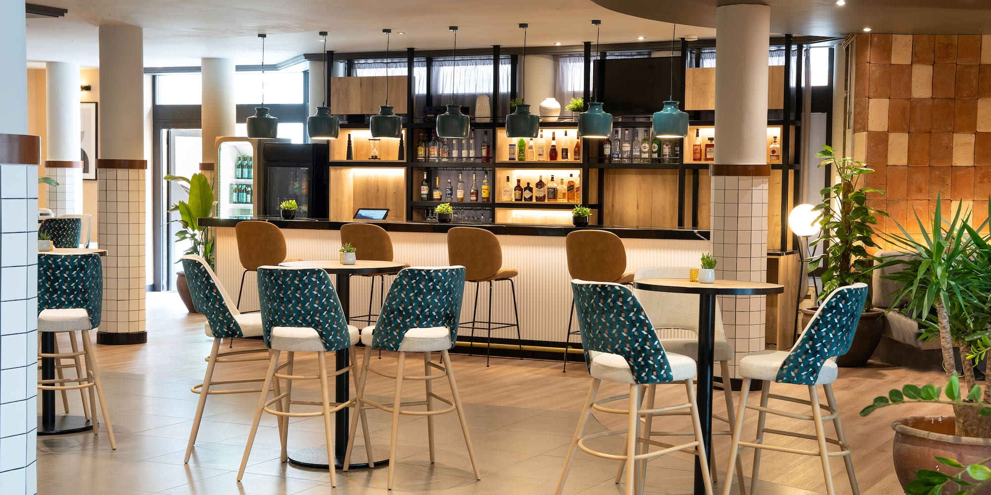 a room with a bar and chairs