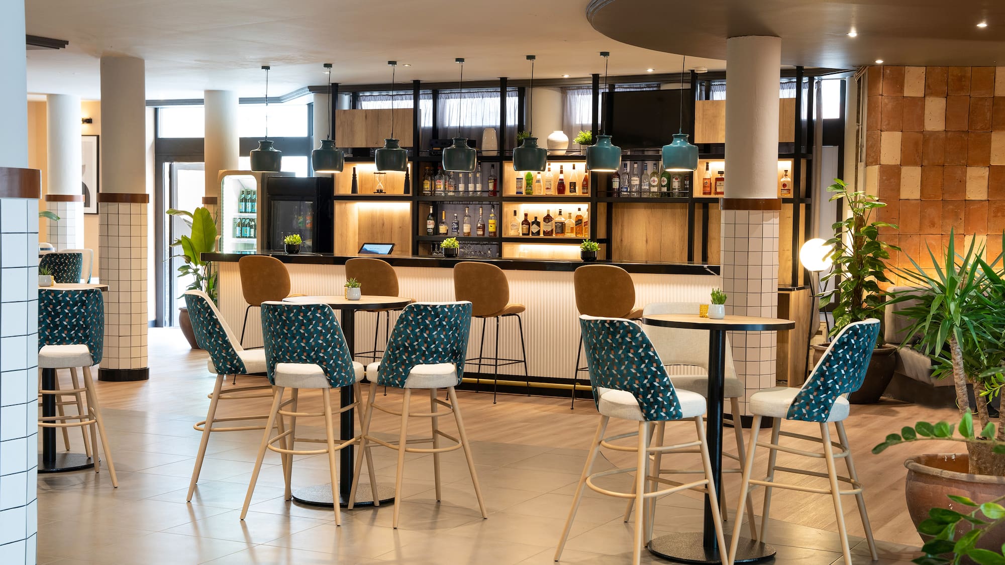 a room with a bar and chairs