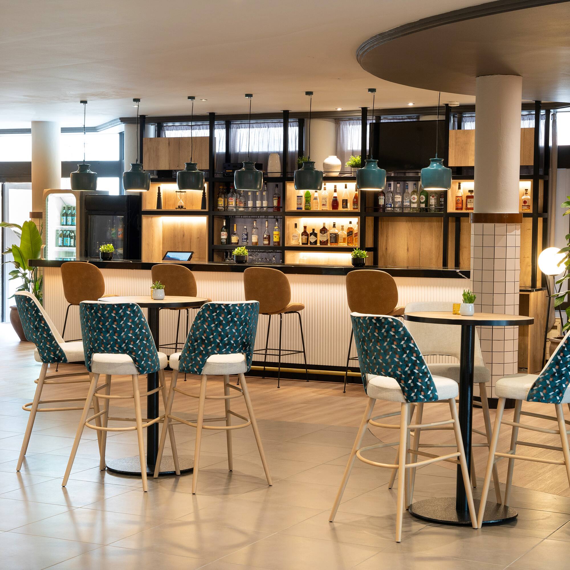 a room with a bar and chairs