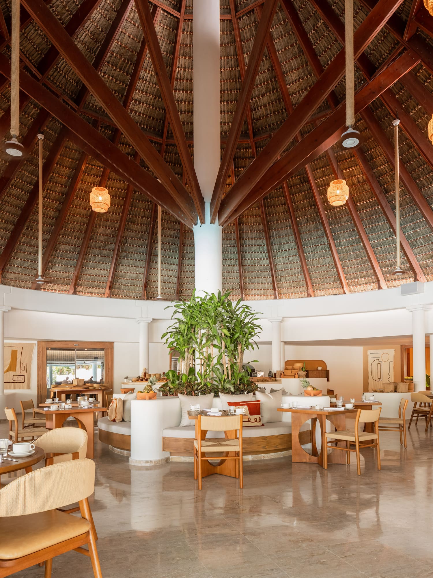 a room with a round ceiling and tables and chairs
