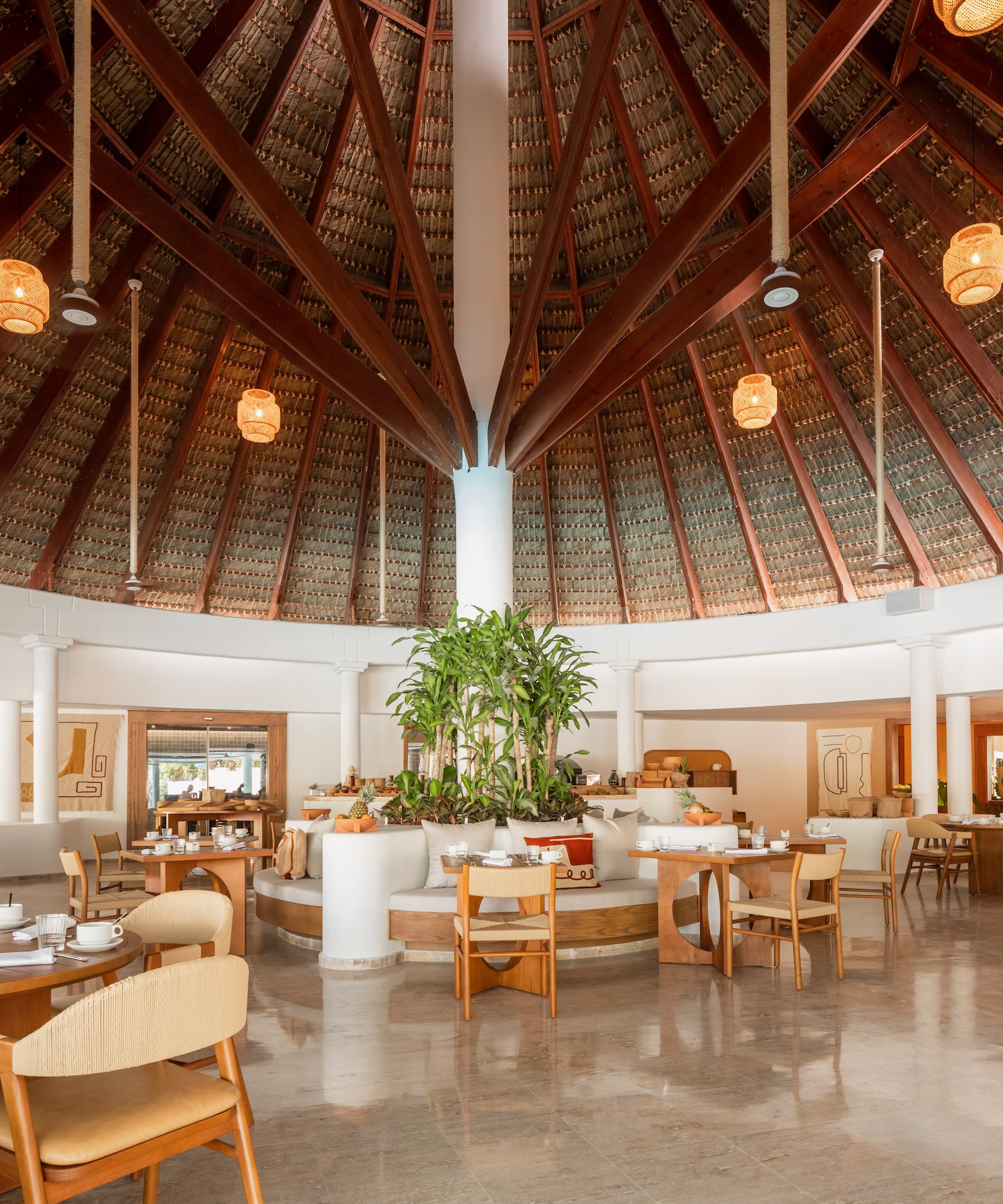 a room with a round ceiling and tables and chairs
