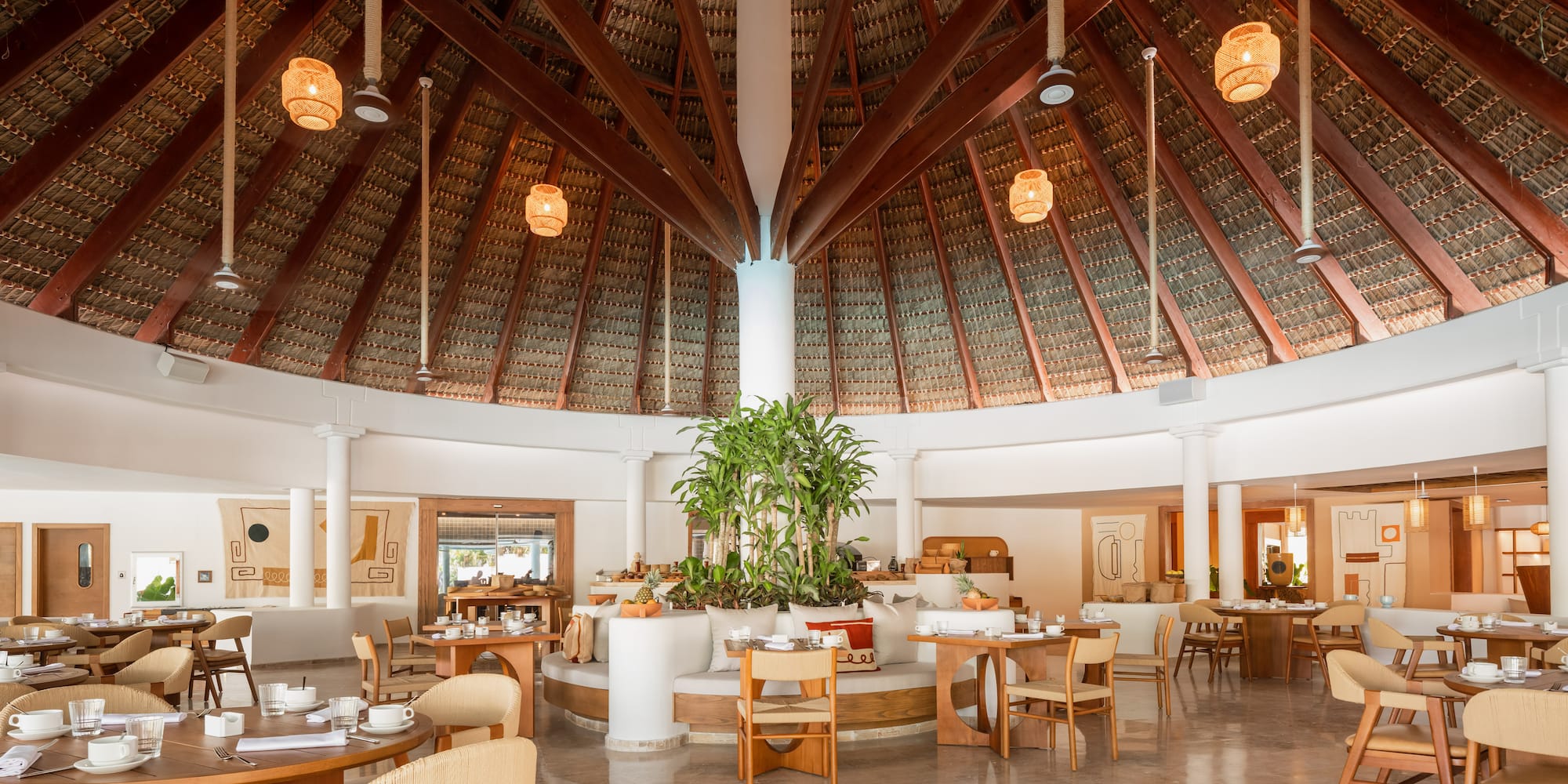 a room with a round ceiling and tables and chairs