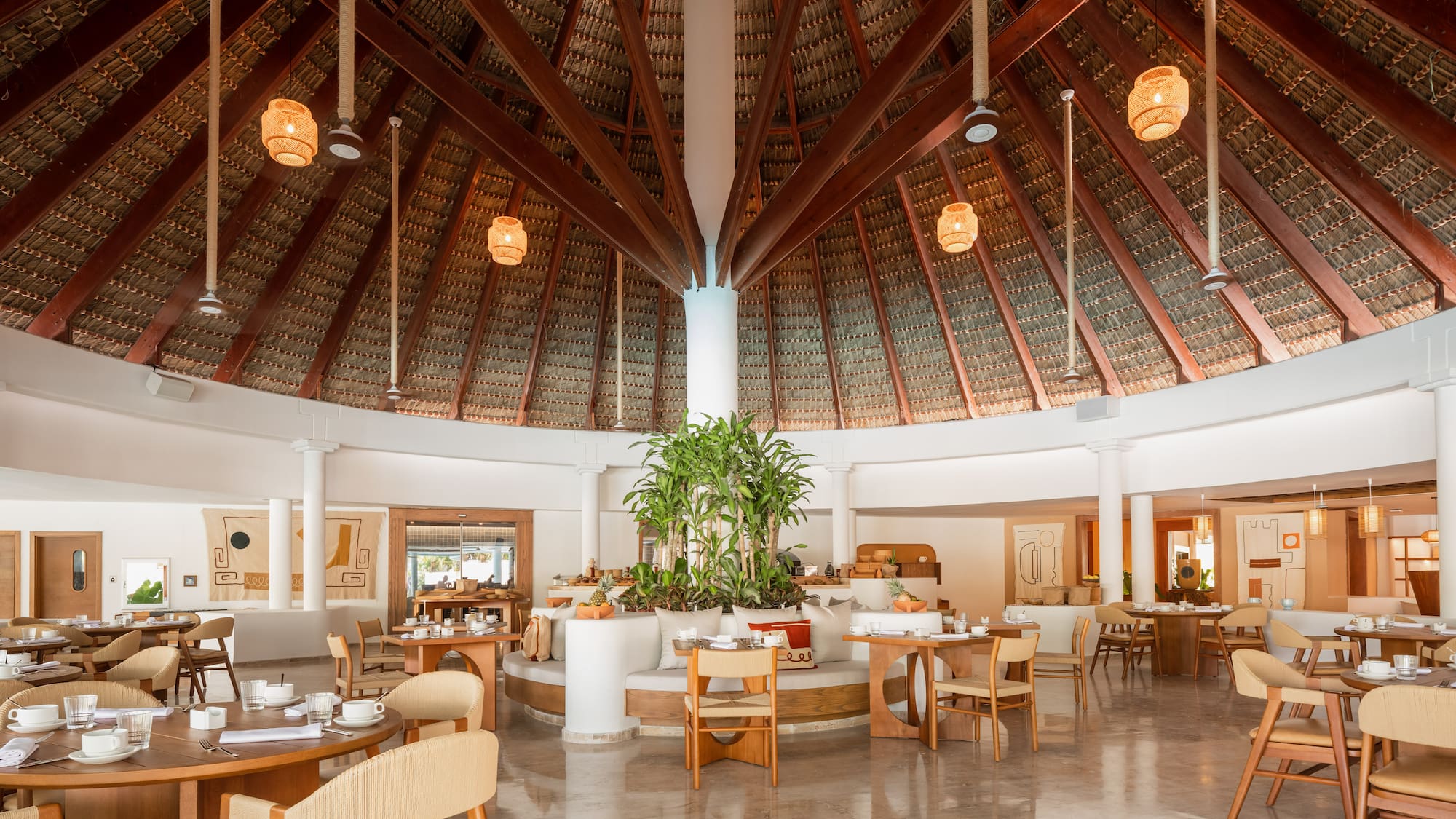 a room with a round ceiling and tables and chairs