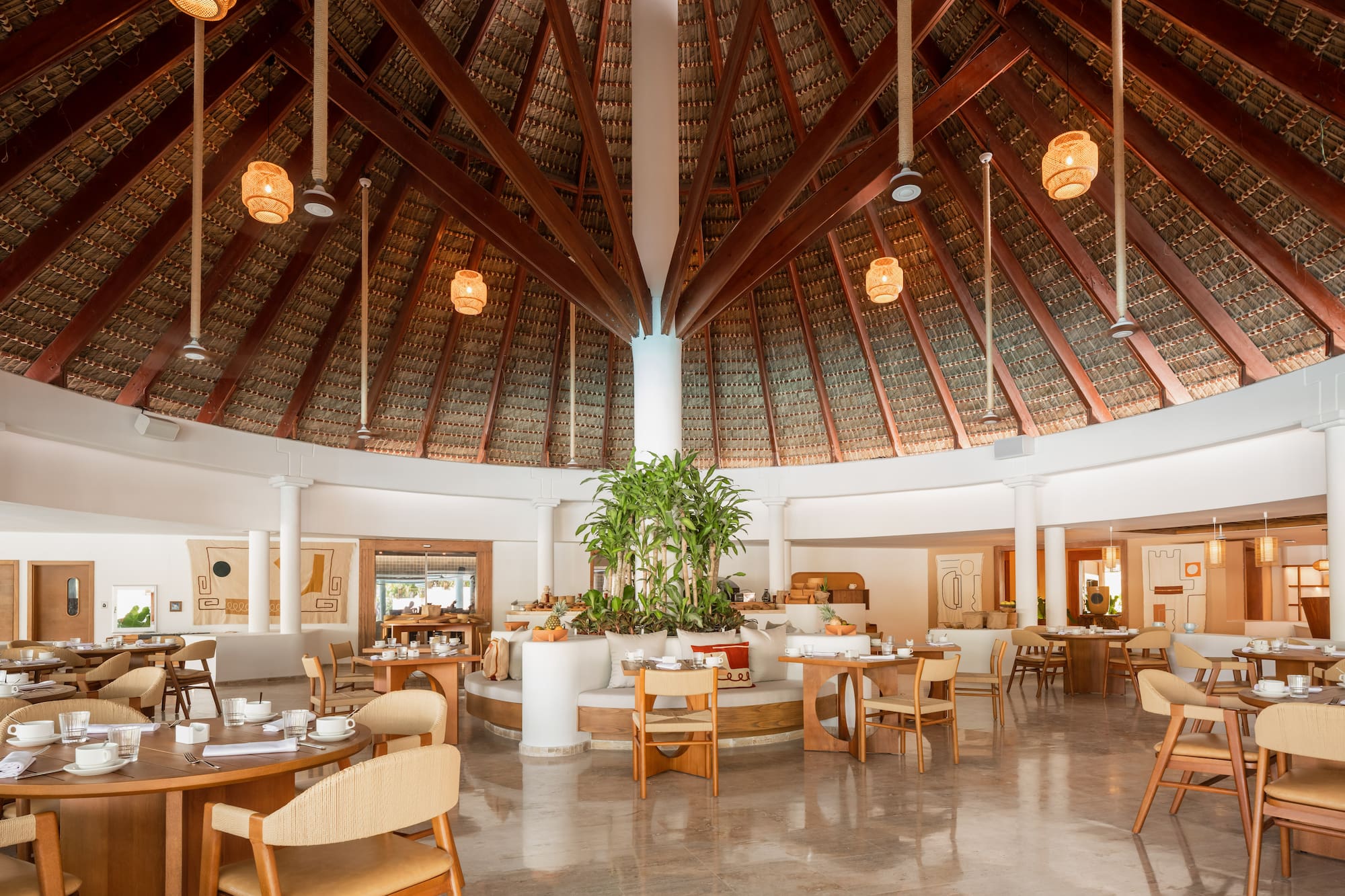 a room with a round ceiling and tables and chairs