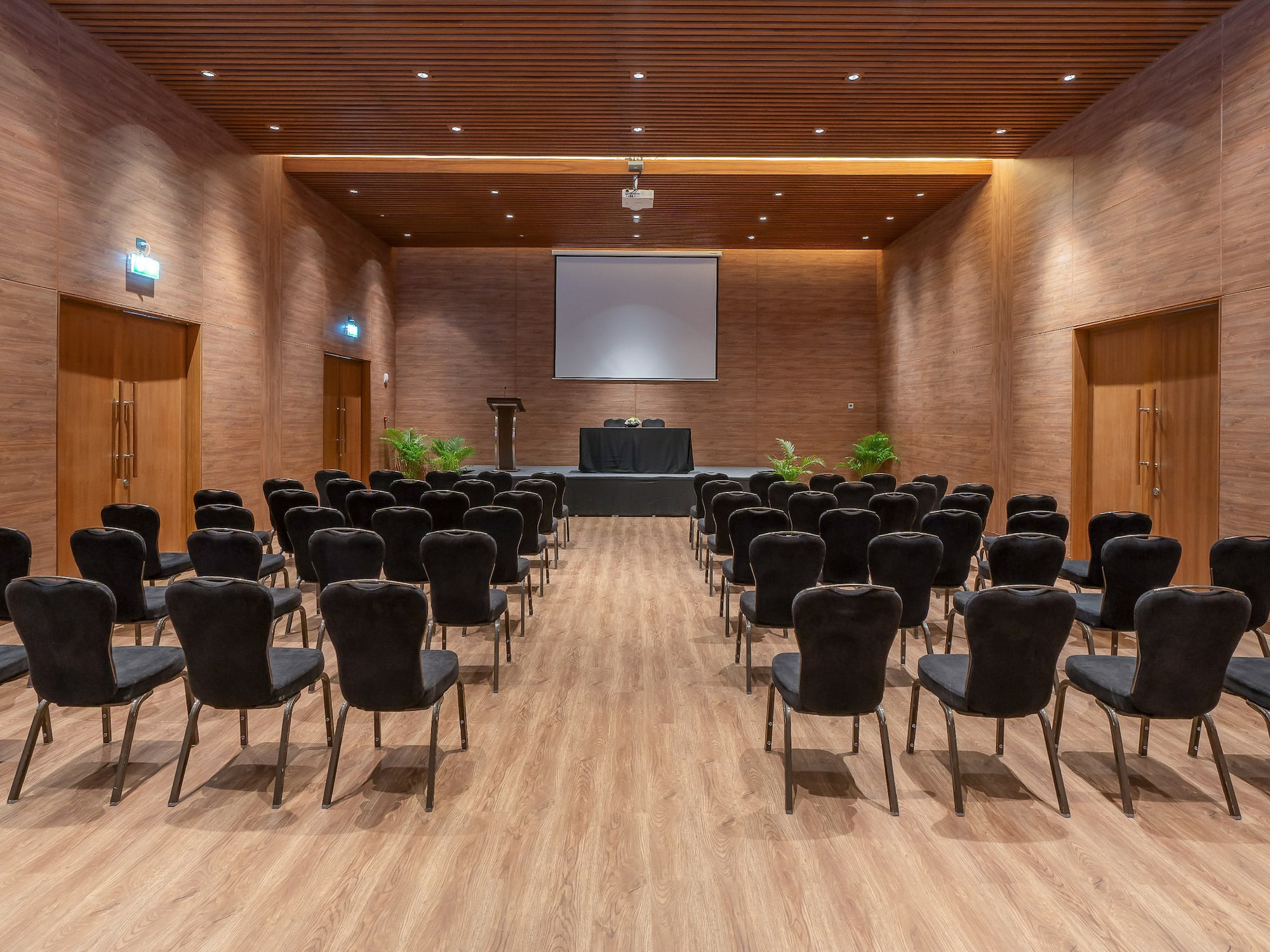 a room with chairs and a projector screen