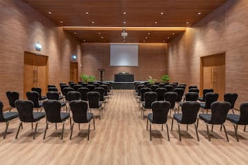 a room with chairs and a projector screen