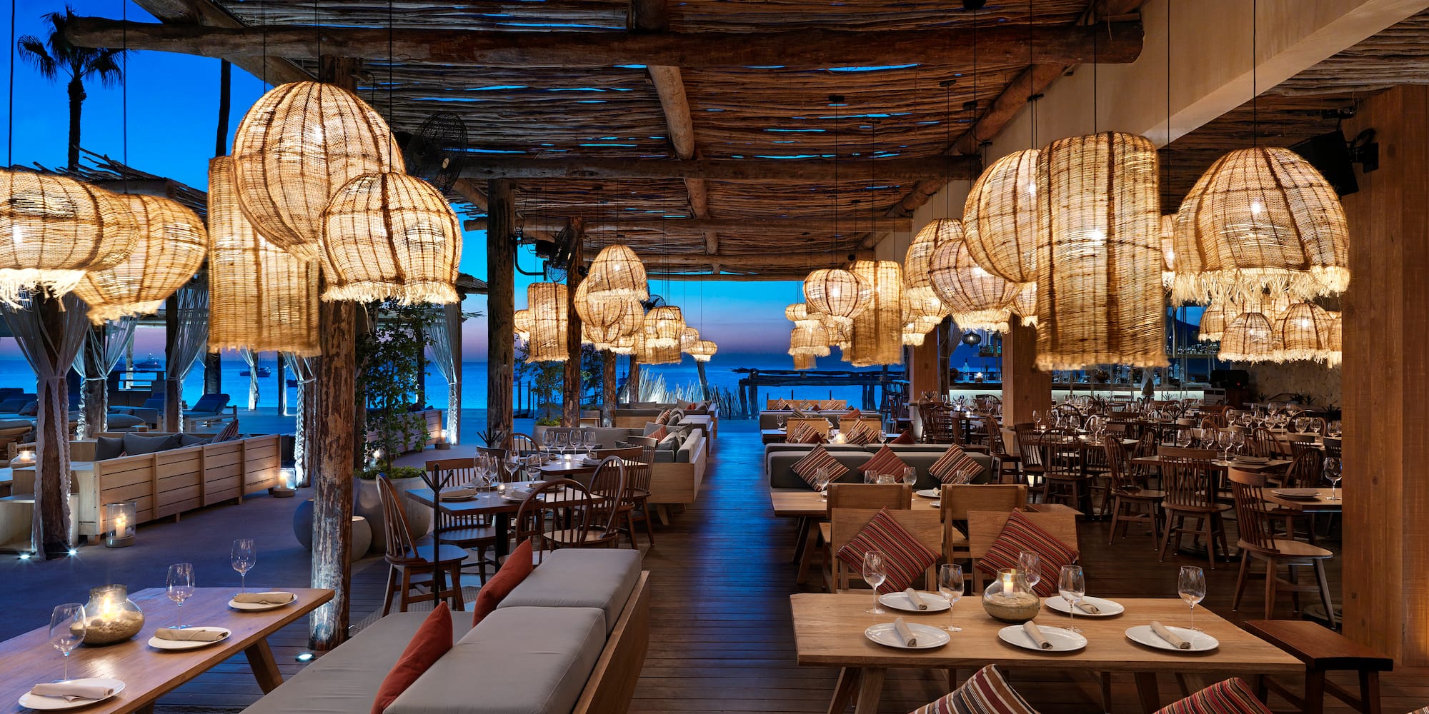 a restaurant with tables and chairs and lamps