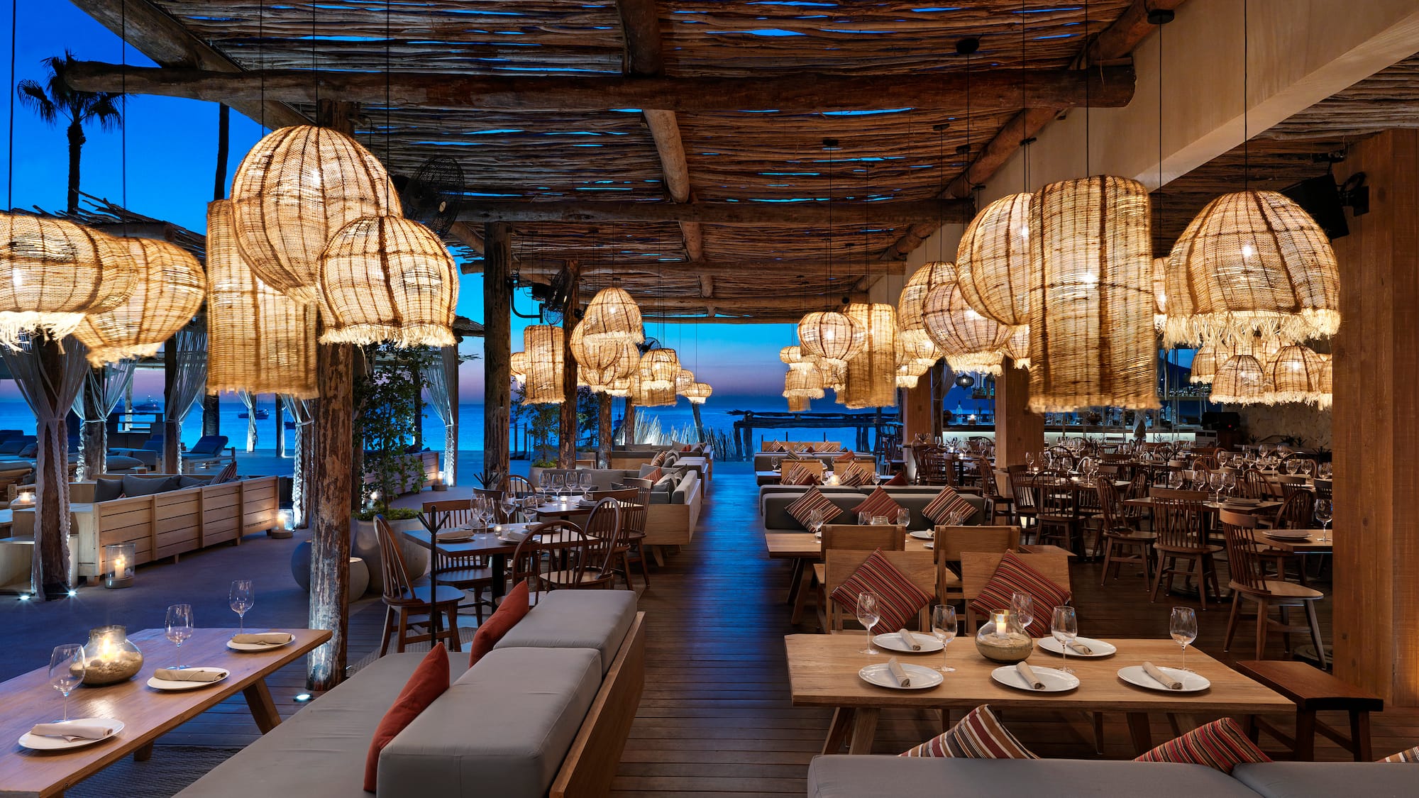 a restaurant with tables and chairs and lamps