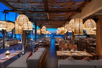 a restaurant with tables and chairs and lamps