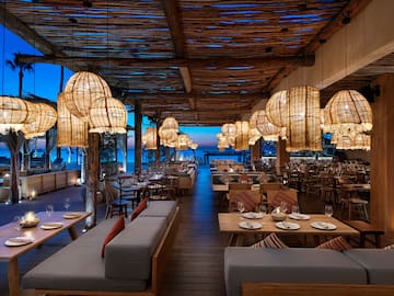 a restaurant with tables and chairs and lamps