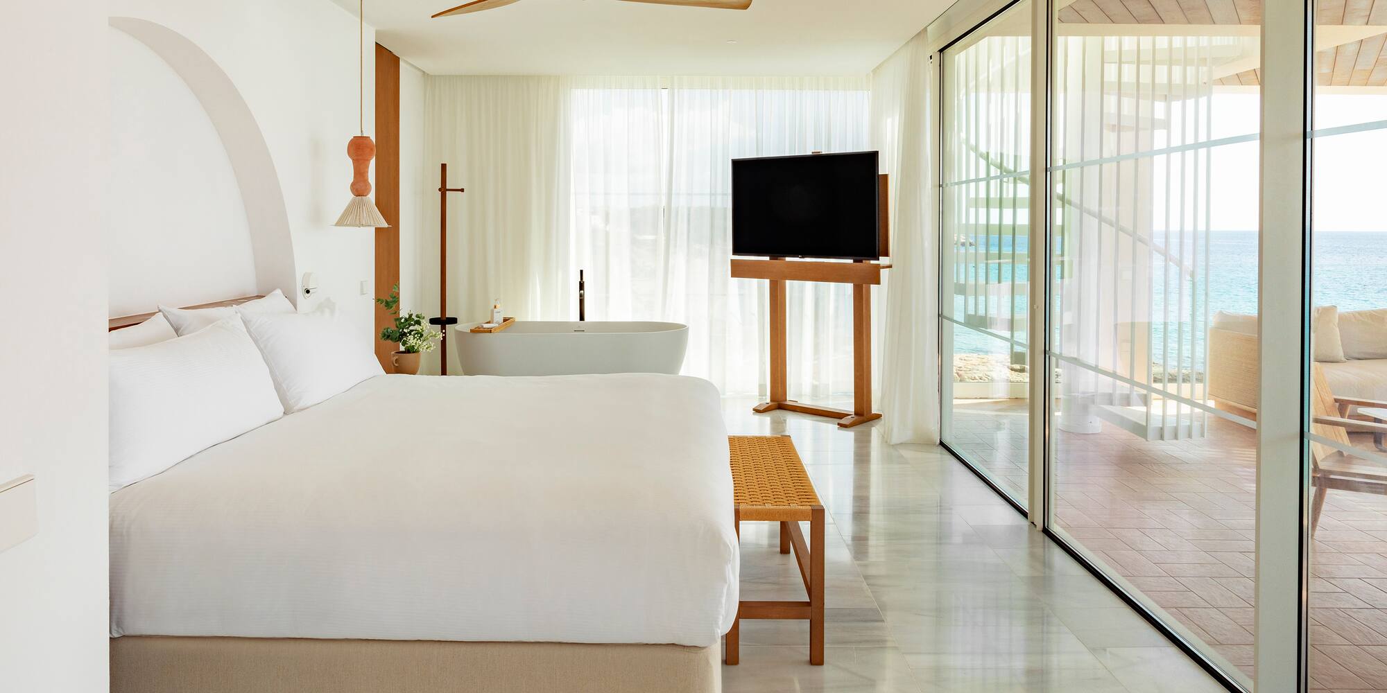 a bedroom with a large bed and a television