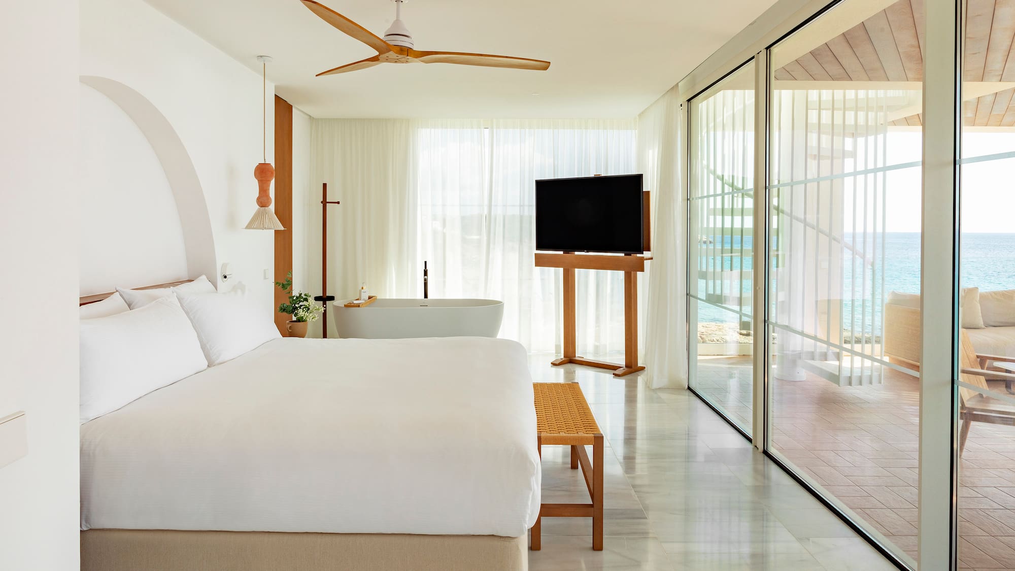 a bedroom with a large bed and a television