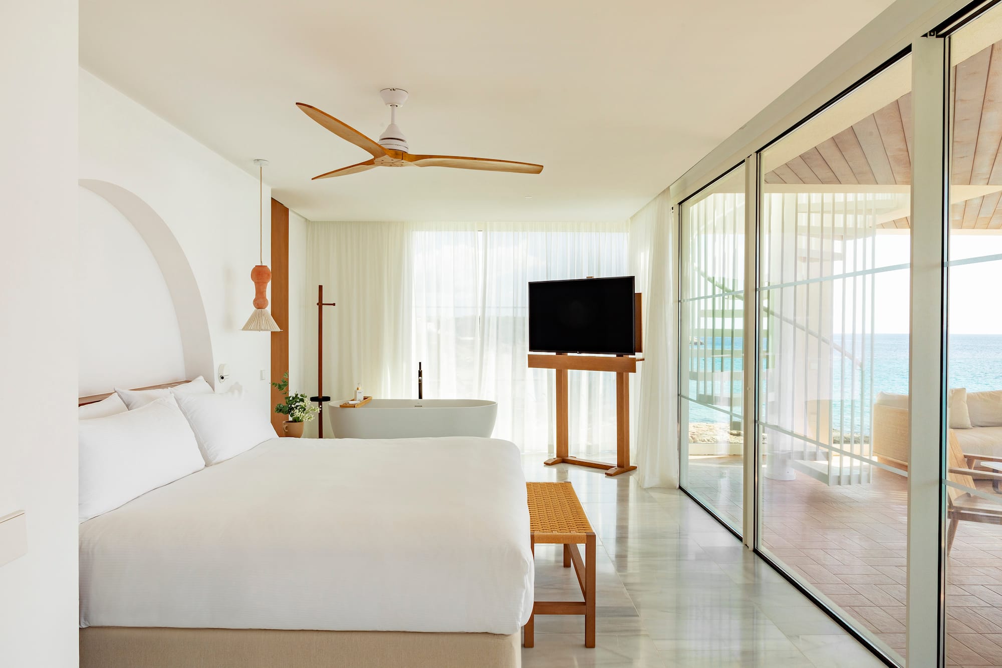 a bedroom with a large bed and a television