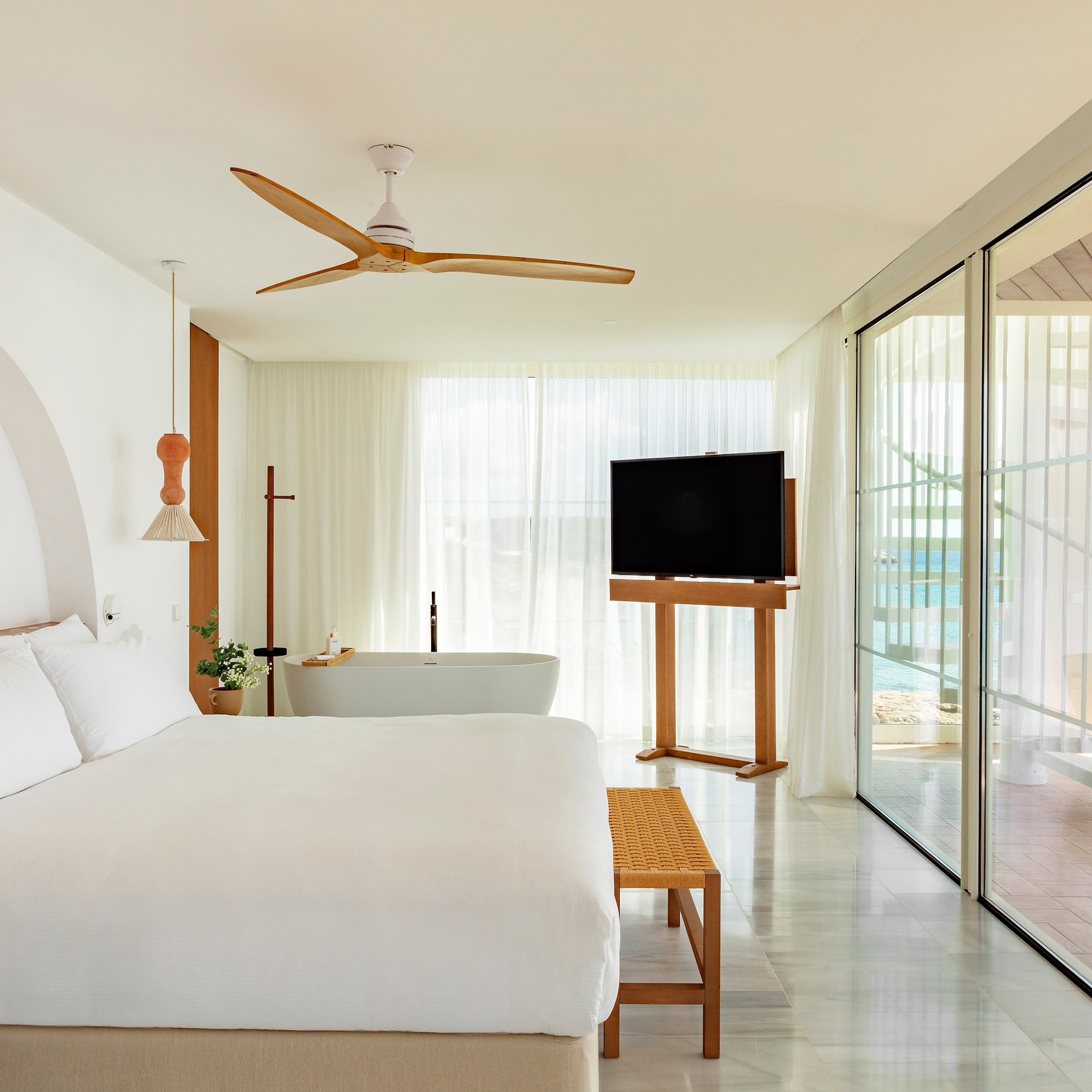 a bedroom with a large bed and a television