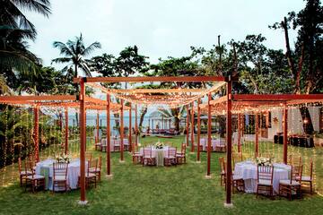 a wedding reception area with tables and chairs