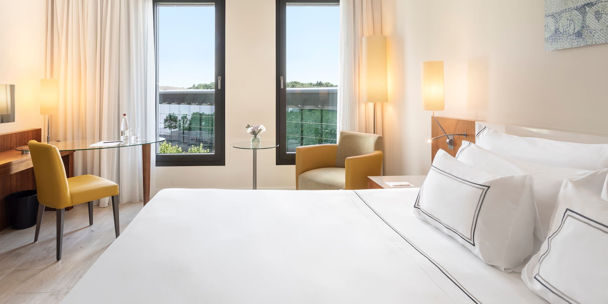 a room with a bed and chairs