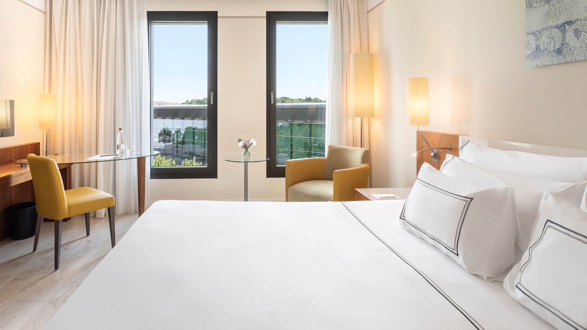 a room with a bed and chairs