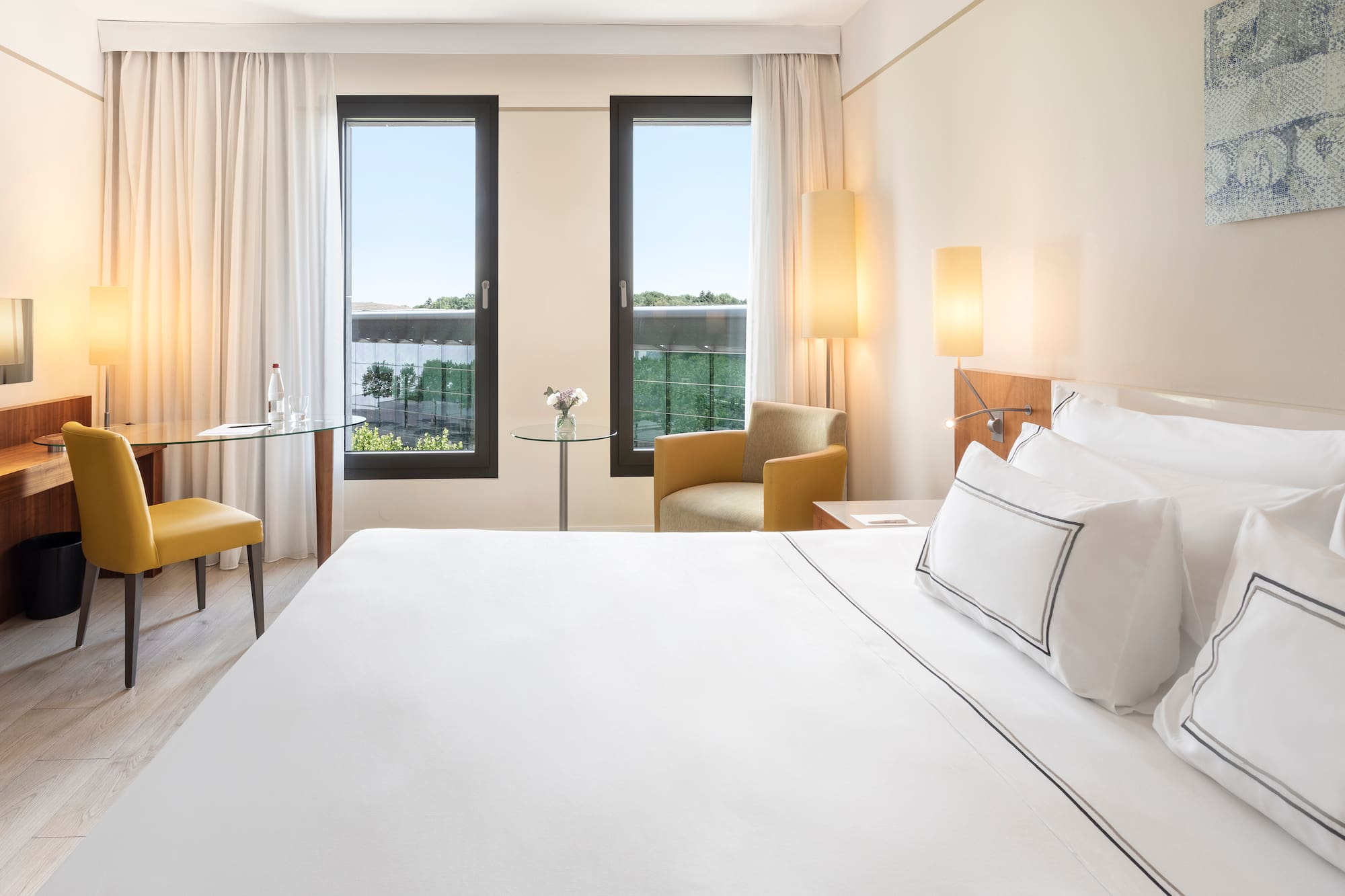 a room with a bed and chairs