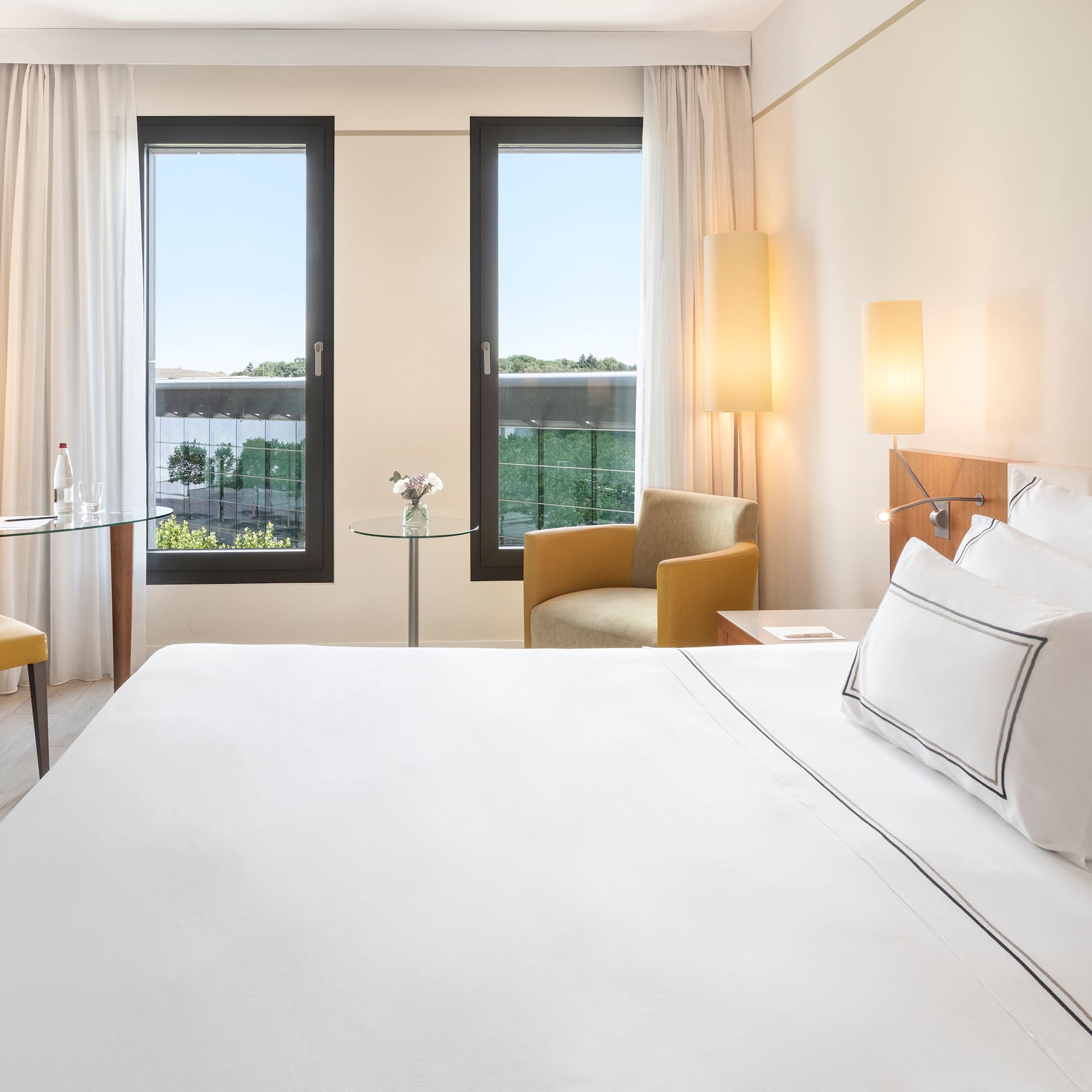 a room with a bed and chairs