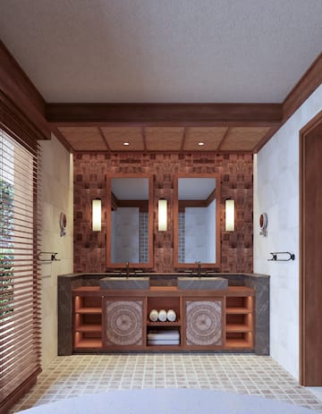 a bathroom with a double sink and mirrors