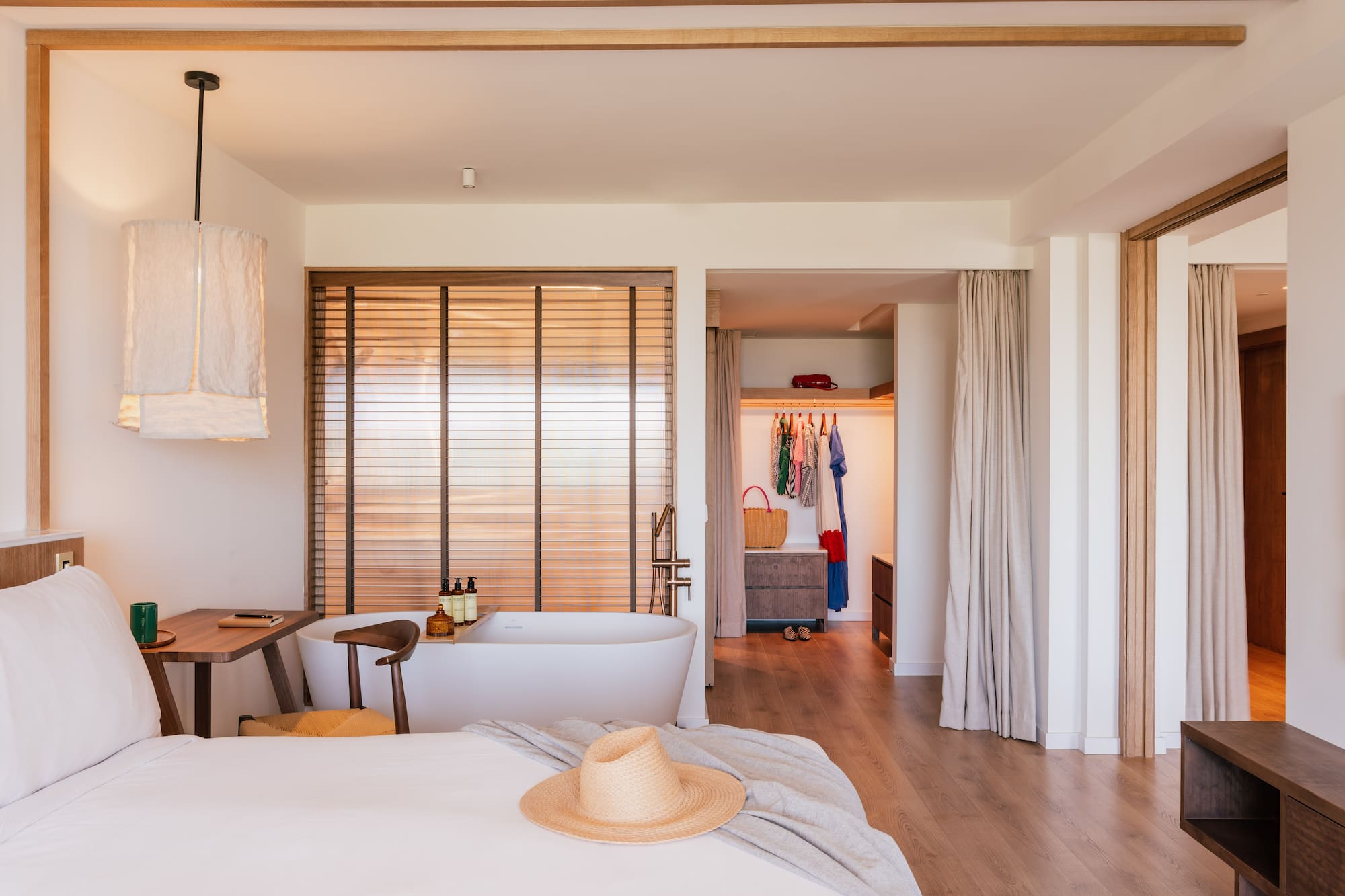 a room with a bed and a bathtub