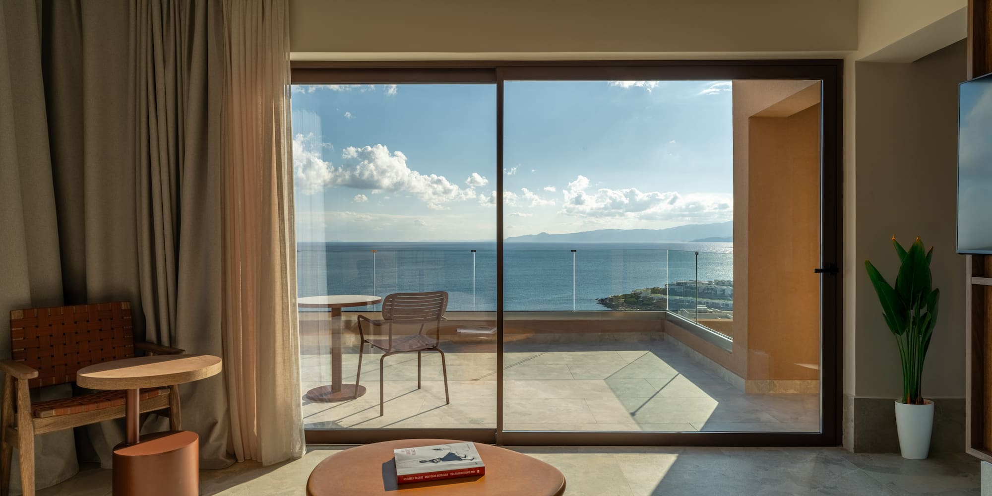 a room with a glass door and a table and chairs