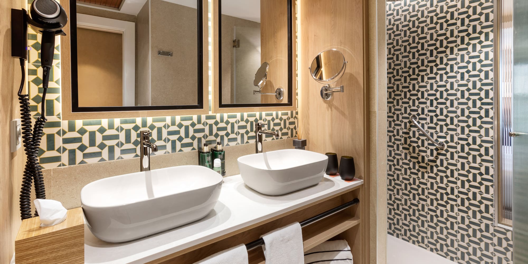 a bathroom with two sinks and a shower