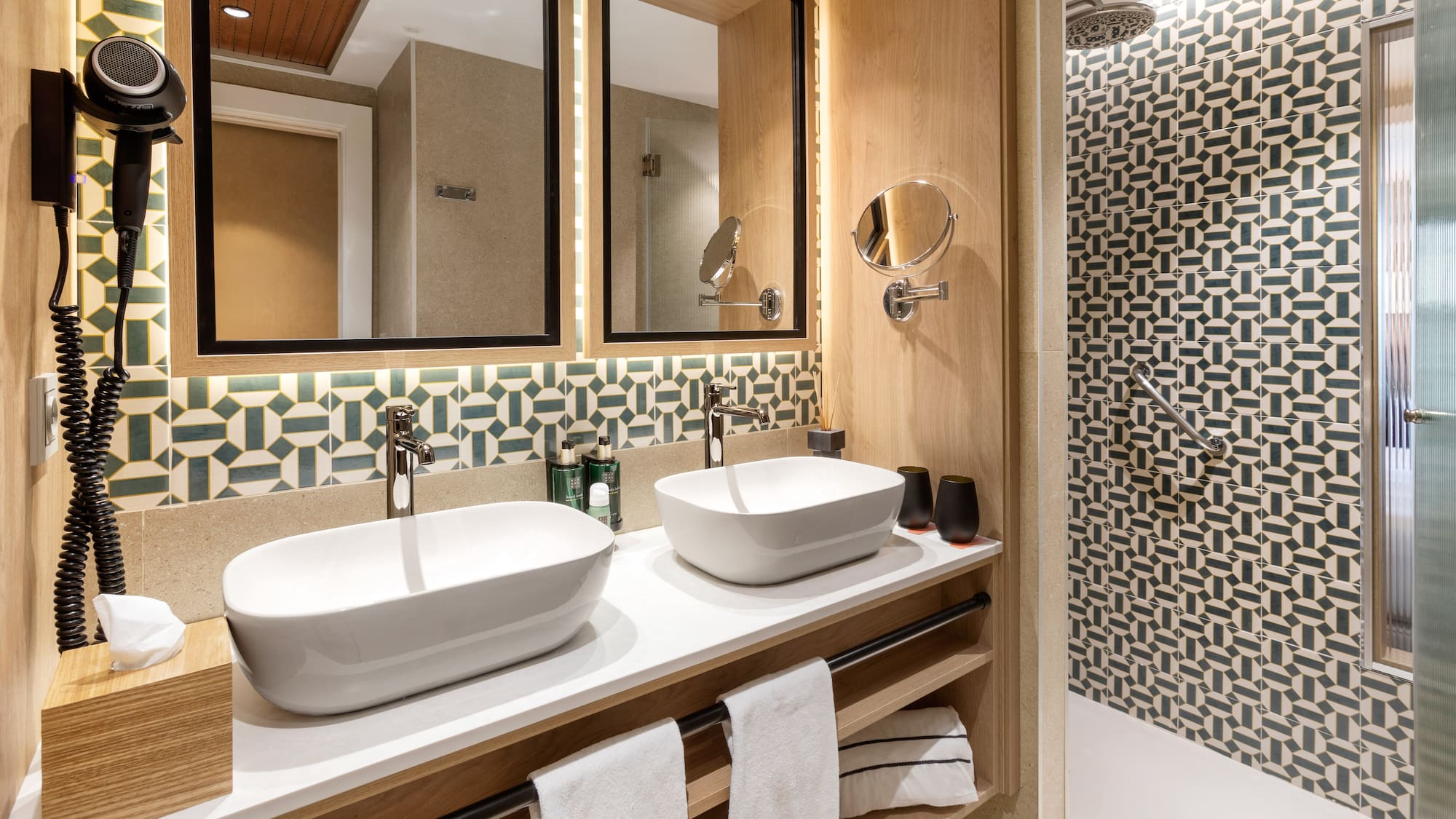 a bathroom with two sinks and a shower