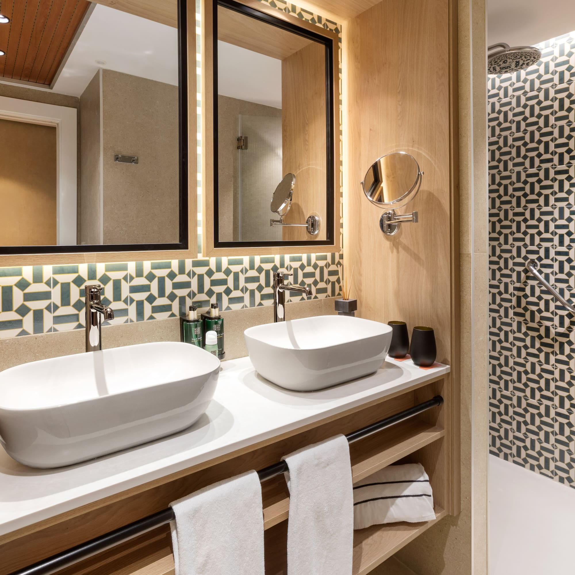 a bathroom with two sinks and a shower