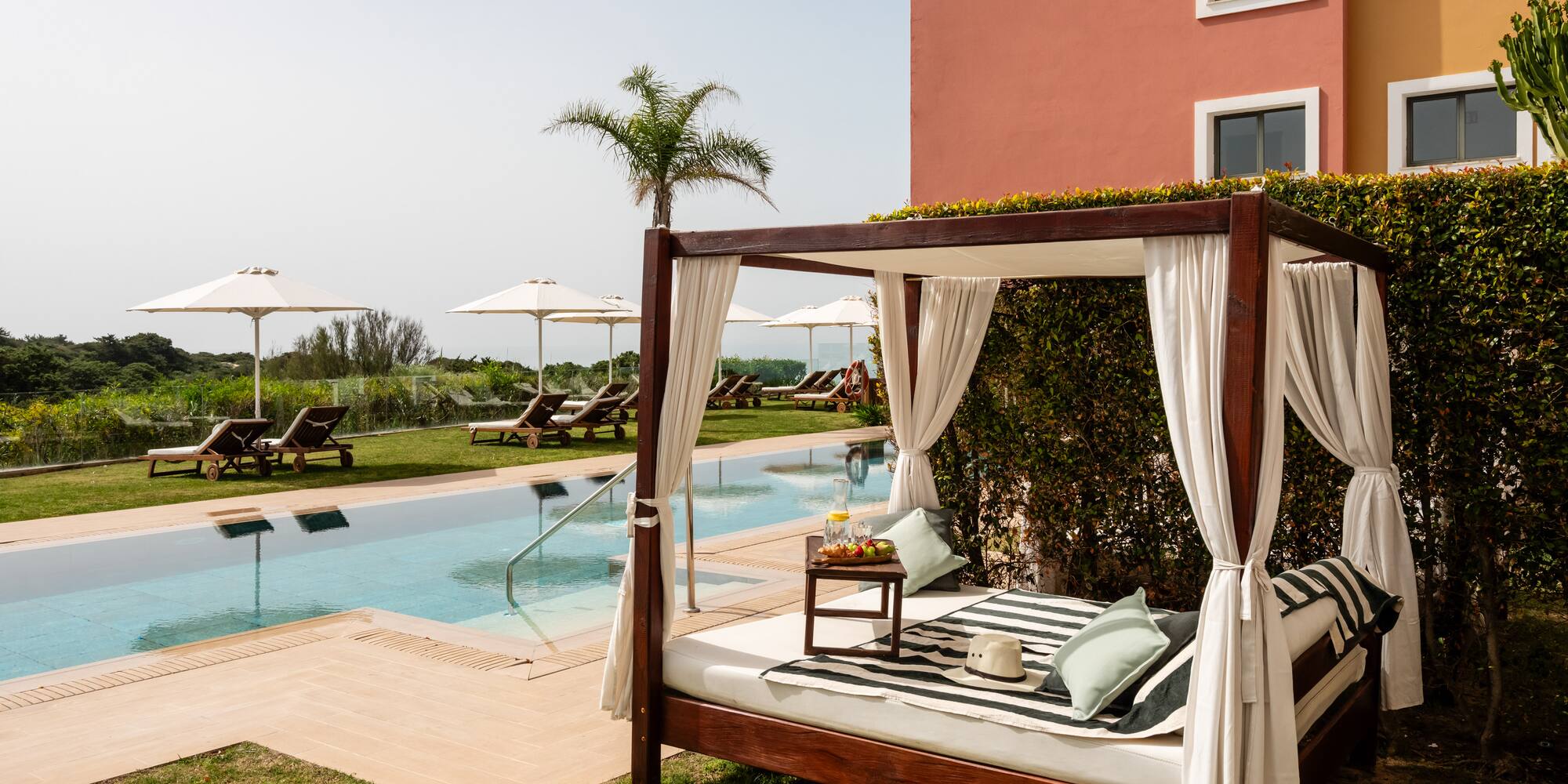 a bed with a pool in the background