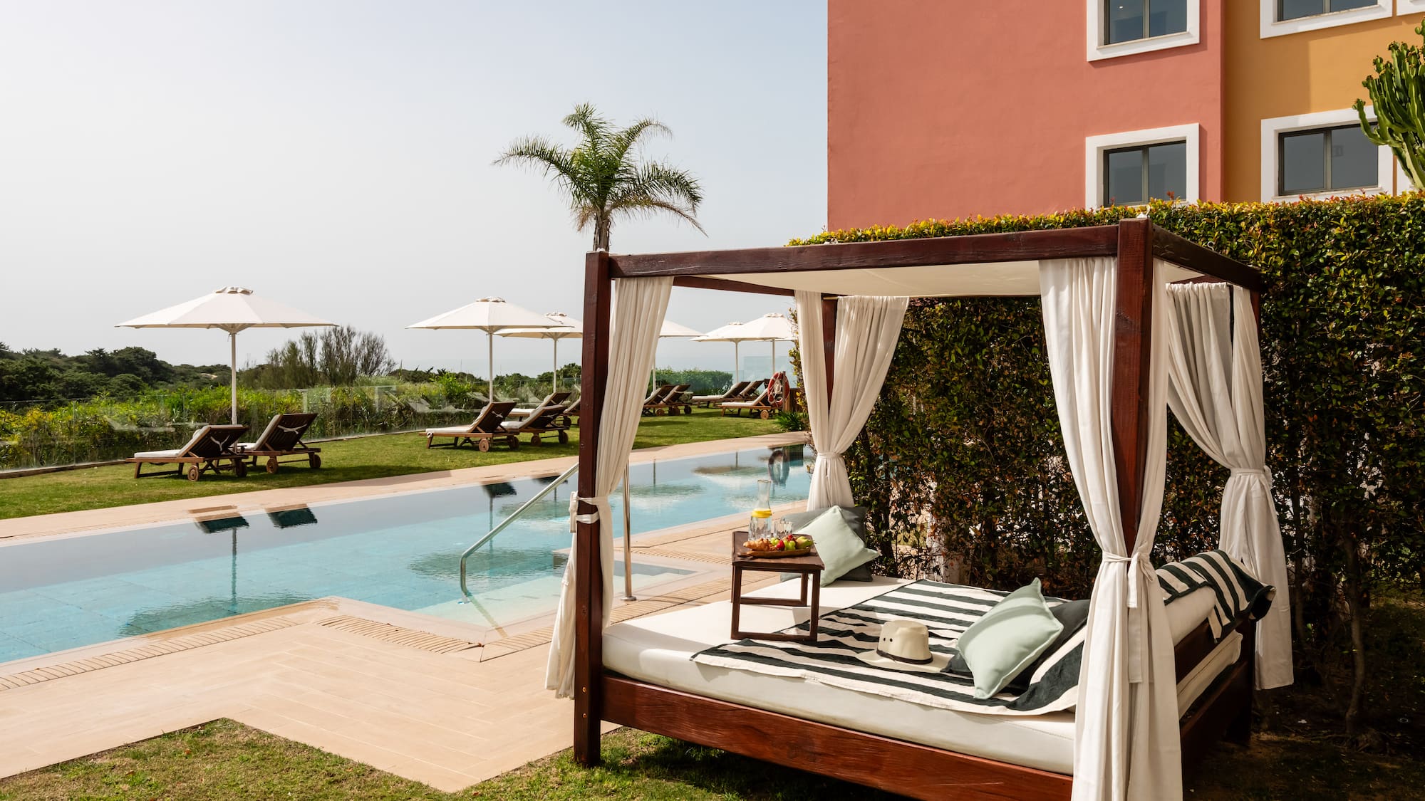 a bed with a pool in the background