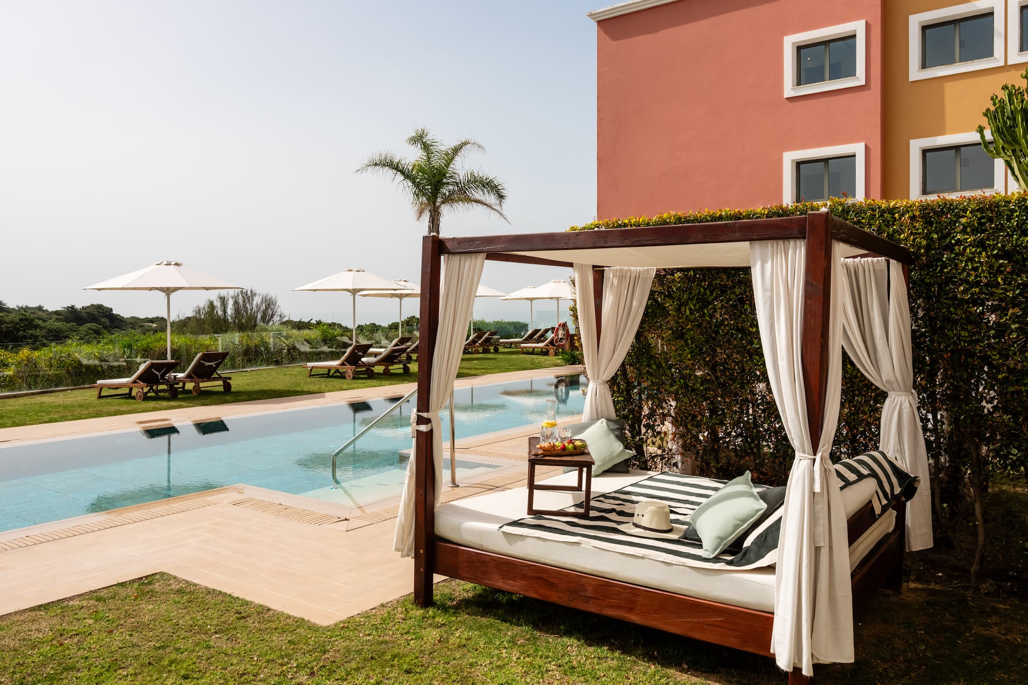 a bed with a pool in the background