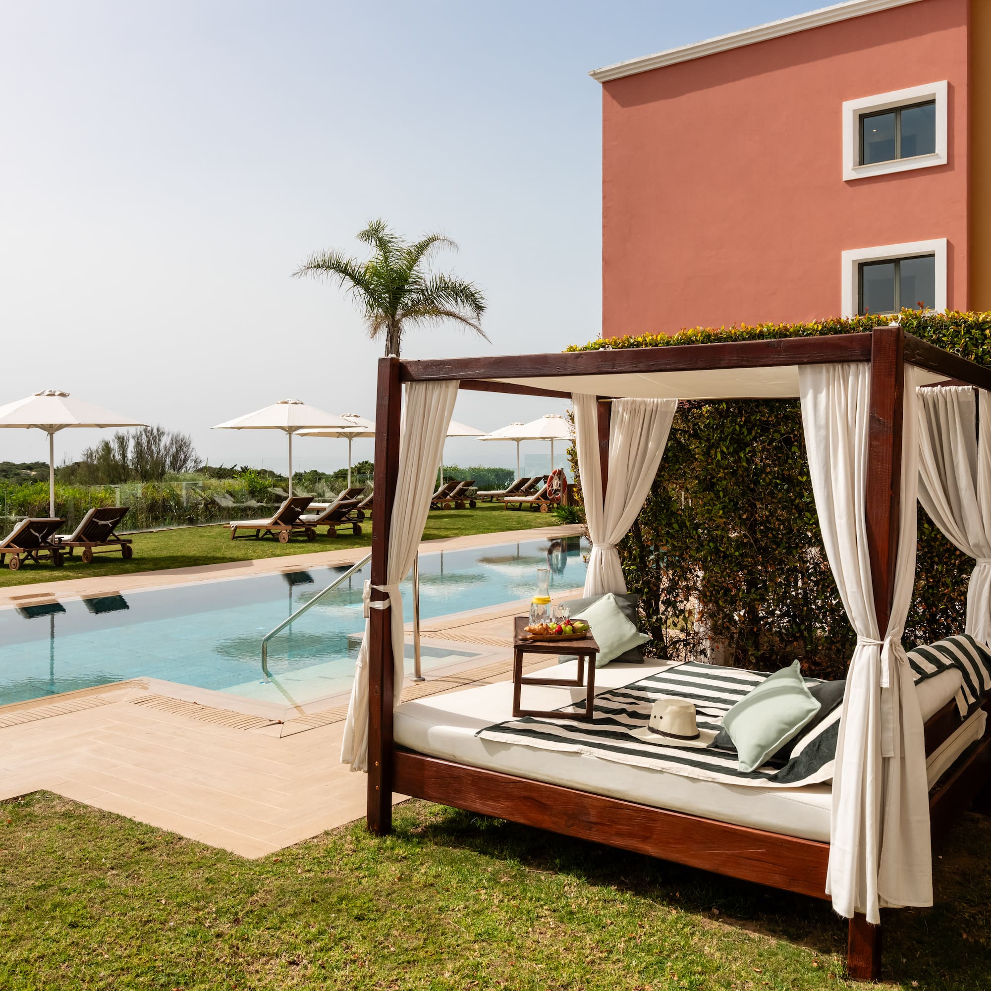 a bed with a pool in the background