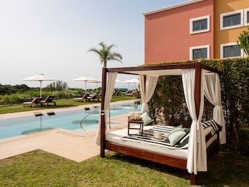 a bed with a pool in the background