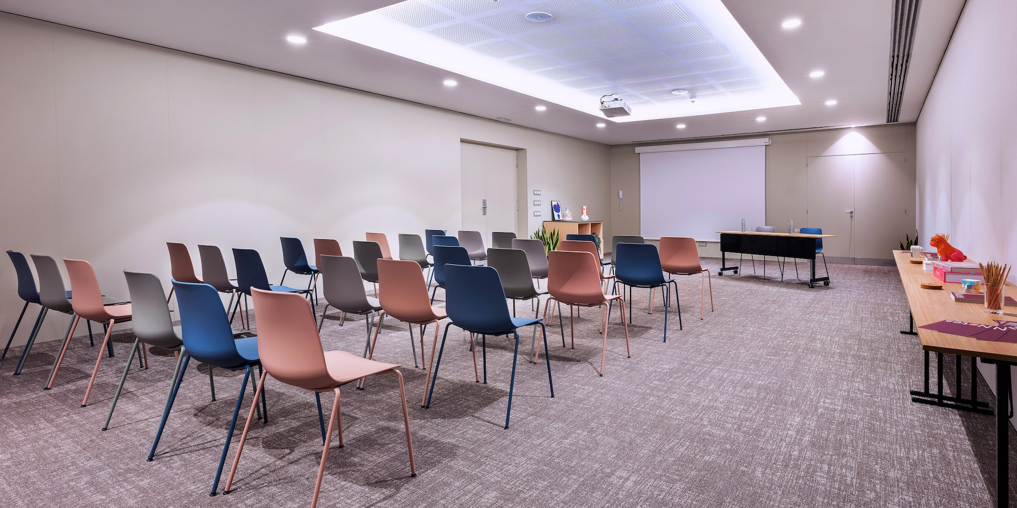 a room with many chairs and a projector screen