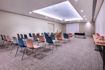 a room with many chairs and a projector screen