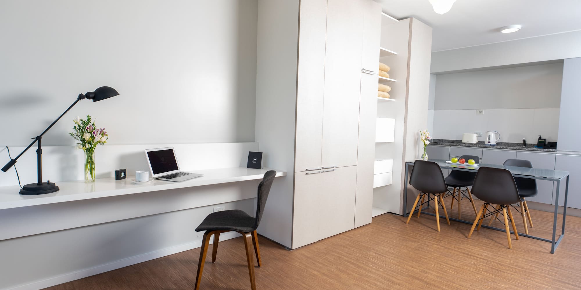 a room with a desk and a laptop