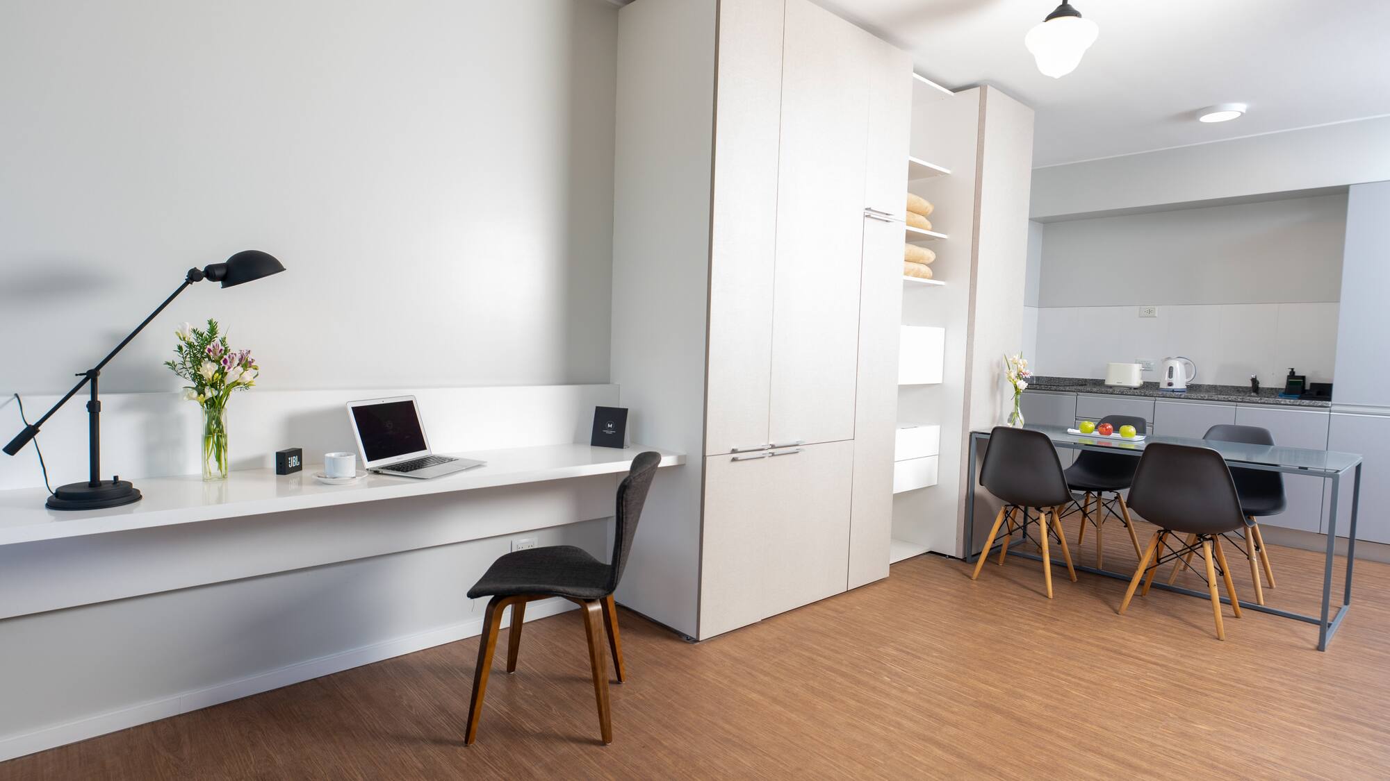 a room with a desk and a laptop